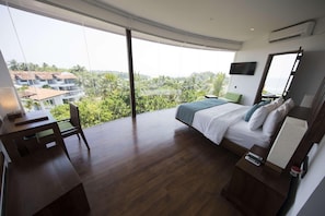Una habitación de hotel moderna con una cama grande, un escritorio y un televisor.