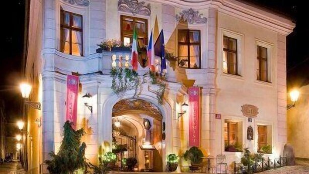 A historic building with a grand entrance, flags, and classical architecture. - Alchymist Grand Hotel and Spa (Prague)