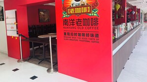A Nanyang Old Coffee shop with a red exterior and a signboard. - Link Hotel (Singapore)