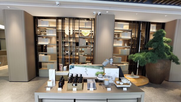 A modern retail display with neatly arranged shelves and a central counter featuring various products. - Ji Hotel (Xiamen)