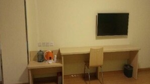 A room with a desk, a chair, a blackboard, and a trash bin. - 7 Days Inn (Dongying)