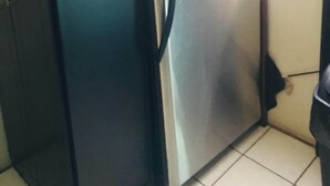 A compact kitchen with a refrigerator, a small cabinet, and a window. - Come, Relax and feel at Home (Tijuana)