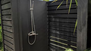 A black metal shower enclosure with a rain shower head and hose.