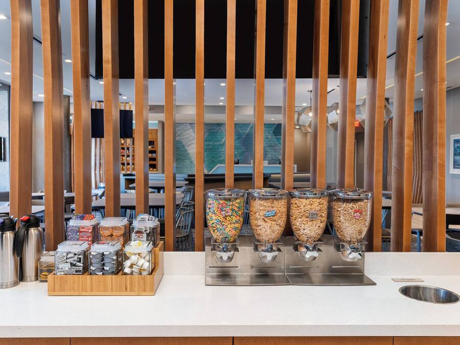 A breakfast bar with cereal dispensers and a coffee station.