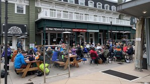 A crowded outdoor dining area with wooden tables and benches, a balcony, and a sign indicating "No Smoking." - #1 Park City Ski-In Ski-Out Luxury, Giant Porch, the Most Amenities, near Main! (Park City)