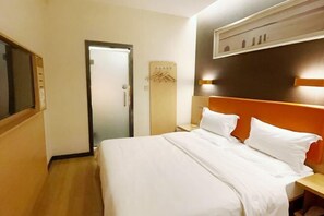 A hotel room with a bed, a nightstand, a wall-mounted TV, a door, and a wall-mounted towel rack. - 7 Days Premium (Chongqing Jiangbei International Airport Shop) (Chongqing)