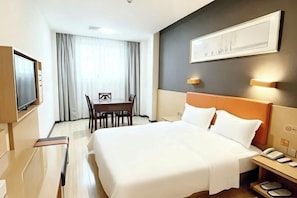 A hotel room with a large bed, a desk, and a television. - 7 Days Premium (Chongqing Jiangbei International Airport Shop) (Chongqing)
