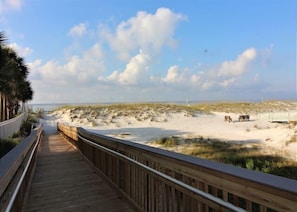 Walk along the boardwalk to the sandy beach.