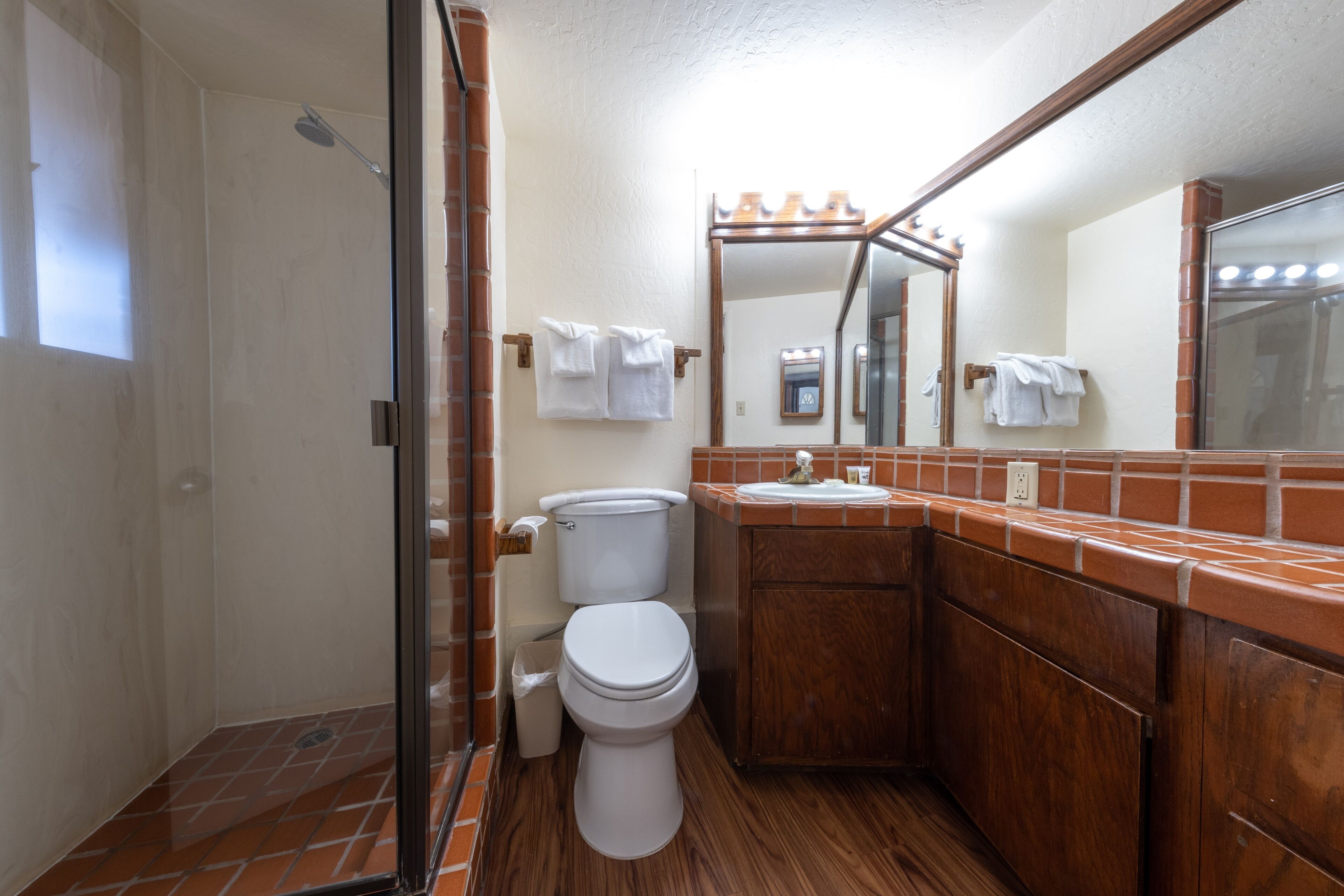 A bathroom with a shower, toilet, and sink.