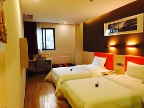 A hotel room with two beds, a small kitchenette, a window, and a wall-mounted picture. - 7 Days Premium (Guangzhou Zengcheng Xintang Light Rail Metro Station) (Guangzhou)
