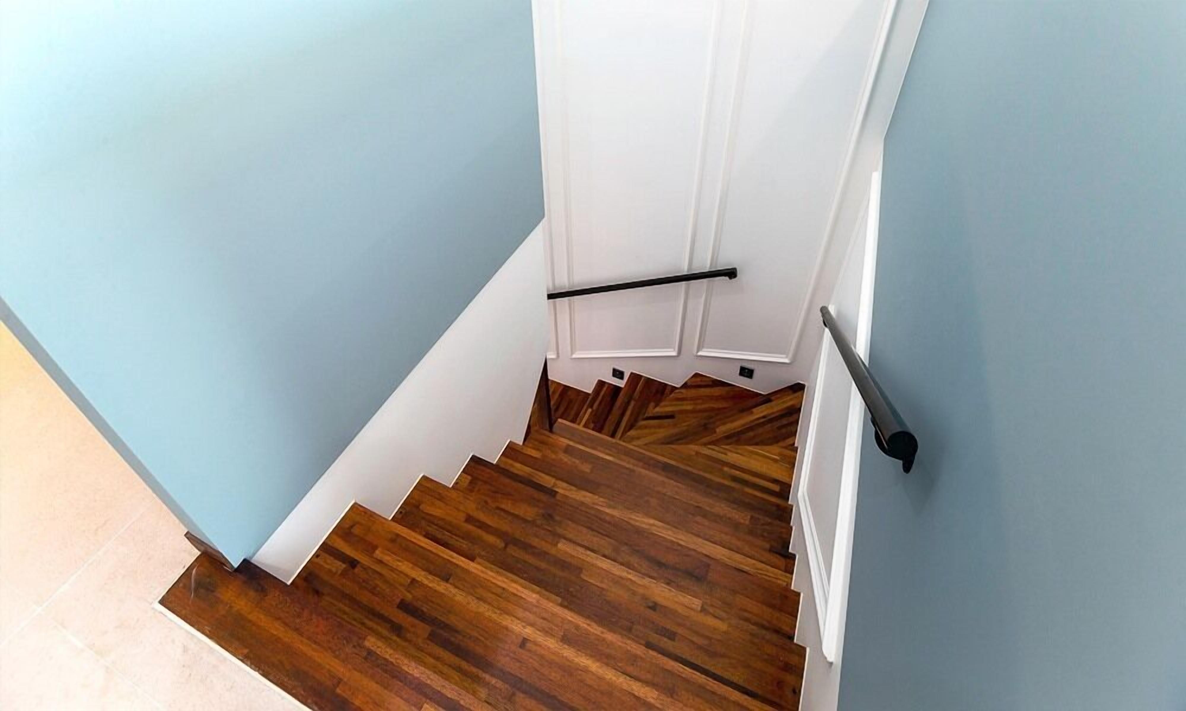 A staircase with wooden steps and white walls.