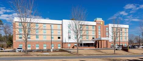 A multi-story hotel with a modern design, featuring a prominent 'HOME2' sign.