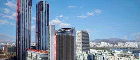 A high-rise building with a modern architectural design, featuring a prominent red and white color scheme.