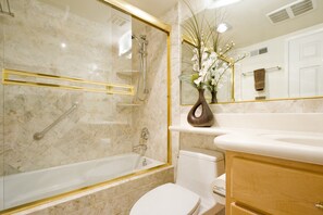 Tina con regadera, secadora de cabello, toallas, jabón 