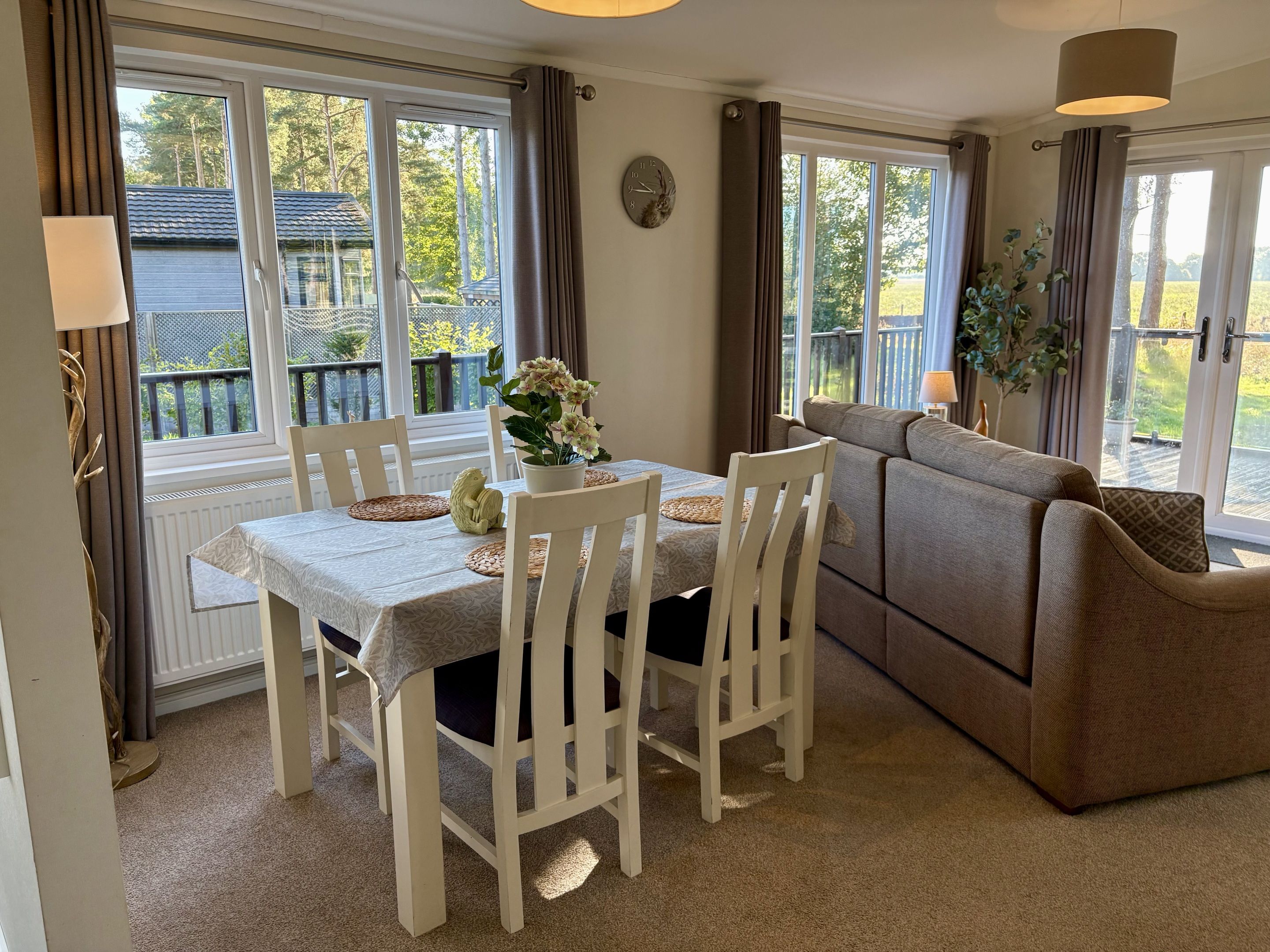 A dining area with a table, chairs, and a sofa.