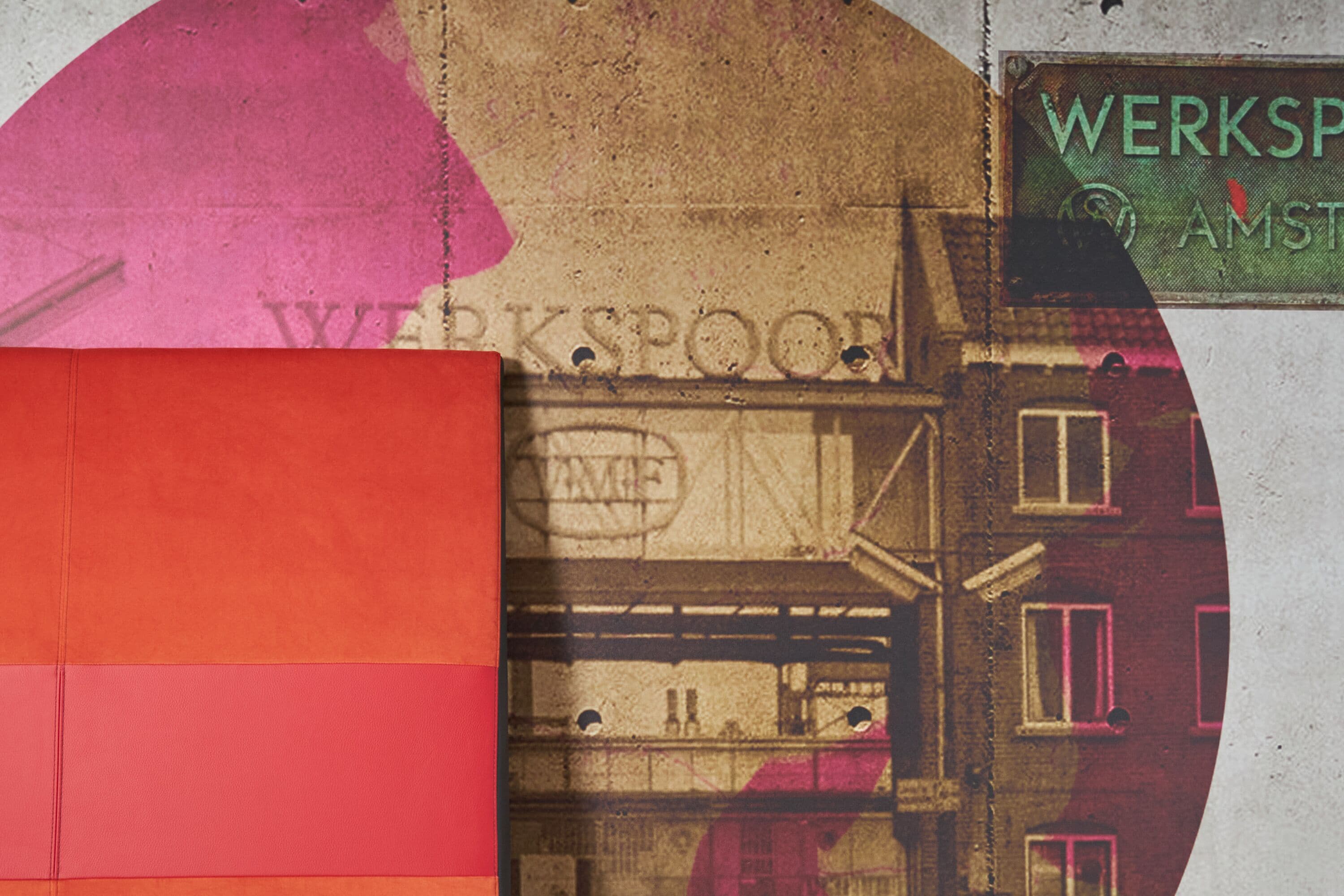 A building with a sign that reads "WERKSPROOF AMSTERDAM."