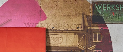 A building with a sign that reads "WERKSPROOF AMSTERDAM."