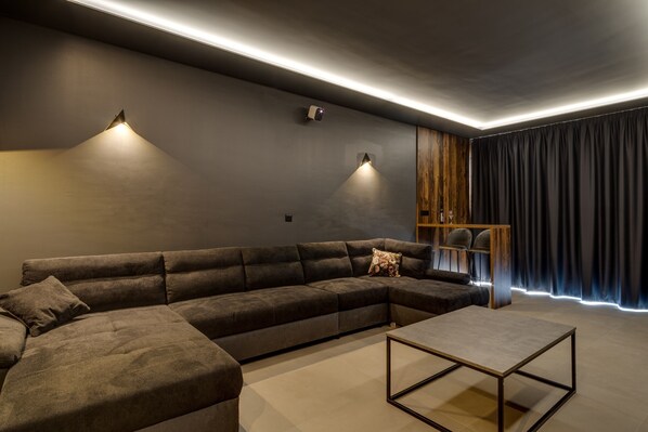 A modern living room with a sectional sofa, a coffee table, and built-in wooden shelving.