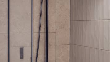 A shower with a handheld showerhead and a fixed showerhead mounted on the wall.