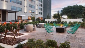A modern outdoor patio area with seating and a fire pit. - Element by Marriott Orlando at SeaWorld (Orlando)