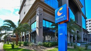 A hotel with a modern facade, large windows, and a prominent blue sign indicating it is a Comfort Suites hotel. - Comfort Suites Sao Jose do Rio Preto (São José do Rio Preto)