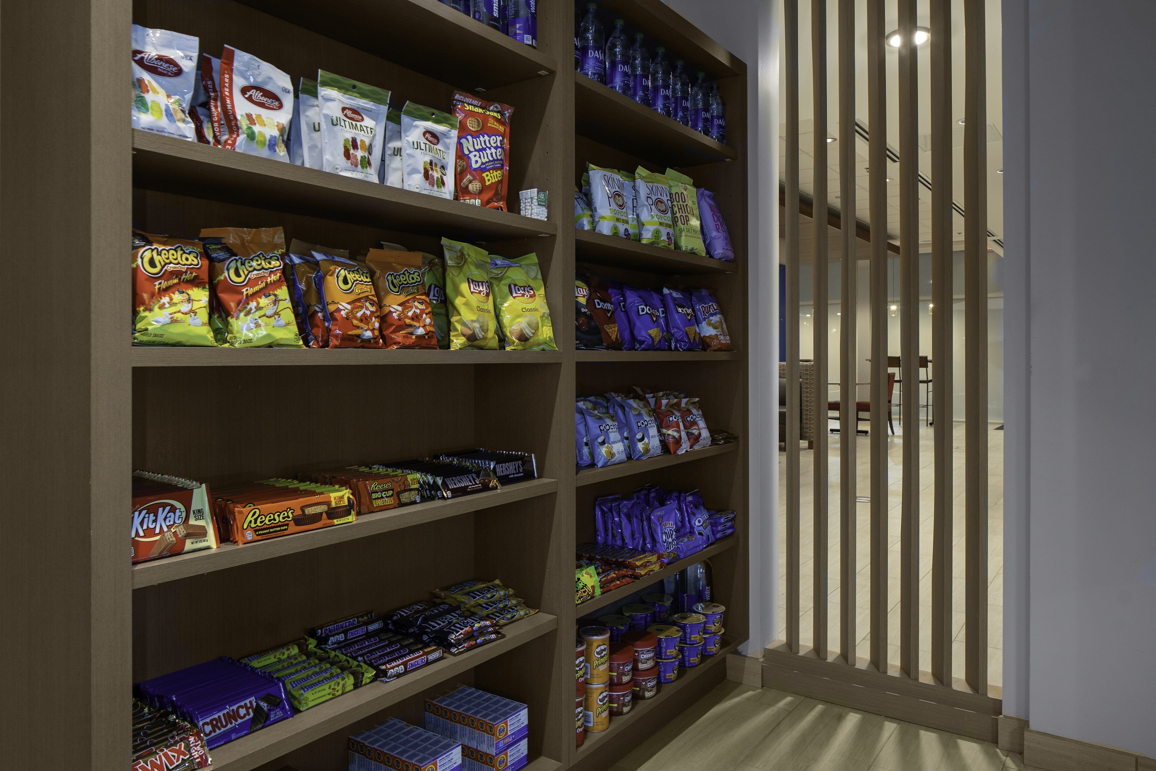 A snack aisle with various packaged snacks and candies.