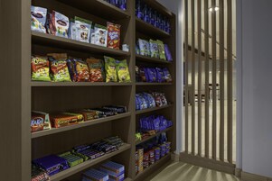 A snack aisle with various packaged snacks and candies.