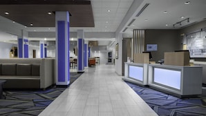 A hotel lobby with a reception desk, seating area, and a patterned carpet. - Holiday Inn Express and Suites Griffin by IHG (Griffin)