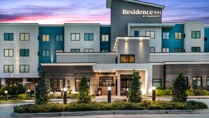 A modern multi-story hotel with a prominent "Residence Inn by Marriott" sign, featuring a clean, contemporary design with a mix of glass and concrete facades. - Residence Inn by Marriott Port Arthur (Port Arthur)