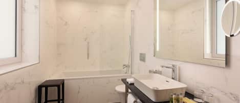 A modern bathroom with a bathtub, a sink, and a toilet.