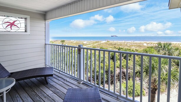 A covered balcony with a view of the beach and ocean. - Oceanfront Townhome w/ Pools, Pet-Friendly, Beach Access Right Out Back Door (Tybee Island)