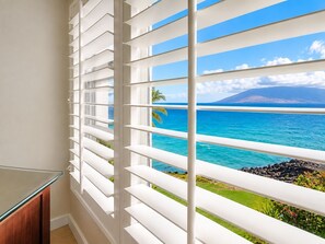 A room with a view of the ocean, white blinds, and a glass table. - Ultra Luxury Oceanfront at Royal Mauian | Fully Renovated and Full Ocean View (Kihei)