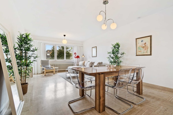 Elegant dining area with contemporary furniture and plenty of natural light, perfect for family meals and gatherings.