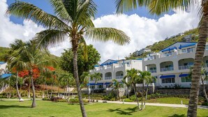 A resort with multiple-story buildings, palm trees, and a well-maintained lawn. - Very Romantic Secluded Beach Getaway in St. Thomas Island (St. Thomas)