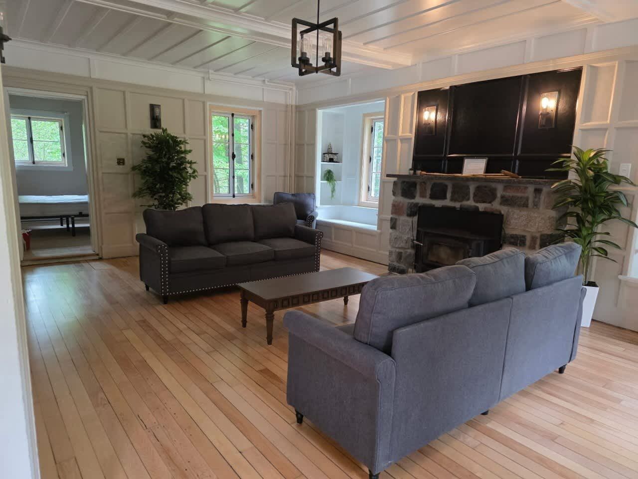 A living room with a fireplace, a sofa, a coffee table, and a television.