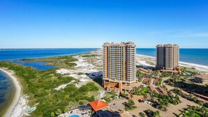 A coastal hotel with two high-rise buildings, a beach, and a pool area. - 21st Floor Penthouse | Portofino Tower 4 (Pensacola Beach)