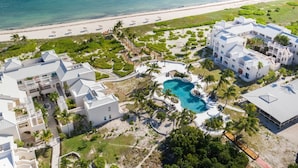 An aerial view of a resort with multiple buildings, a swimming pool, and a beach. - Secluded Retreat, Unbelievable Ocean View, Beach Front (Providenciales)