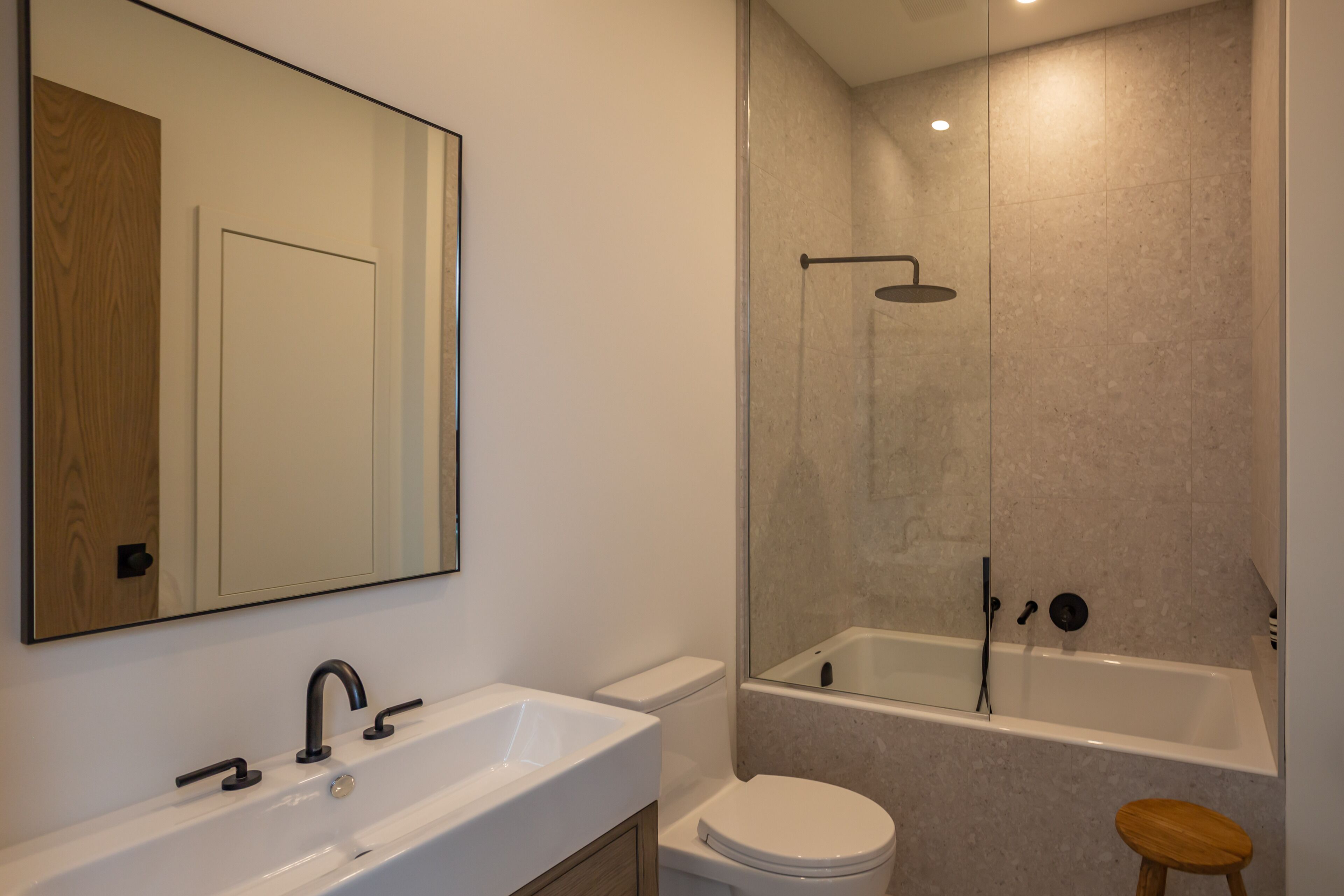 A bathroom with a white sink, toilet, and bathtub.