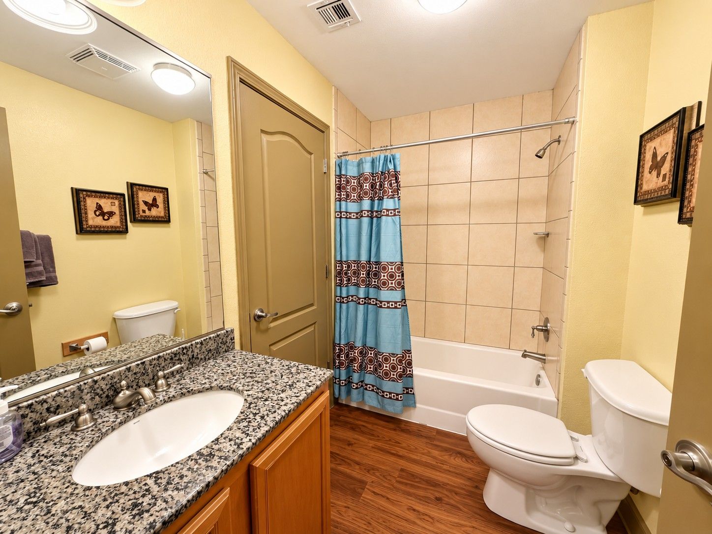 A bathroom with a sink, toilet, and bathtub.