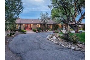 Welcome to this charming two-story home surrounded by mature trees and beautifully landscaped gardens.