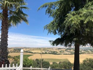 Enjoy breathtaking views of rolling hills and fields from this balcony.