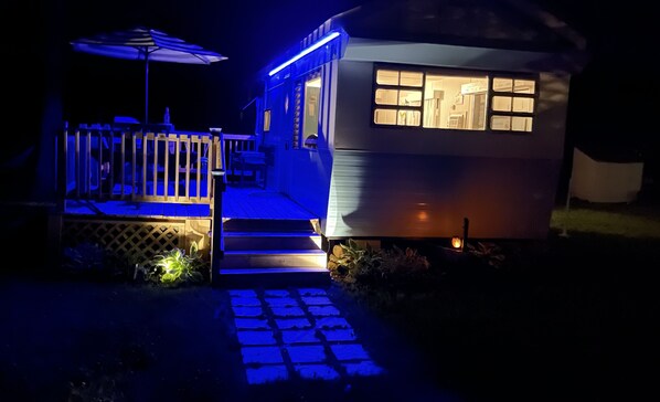 A house with a deck and steps leading to the entrance.