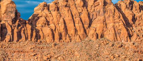 A rocky desert landscape with prominent red sandstone formations.