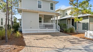 A two-story house with a porch and a garage.