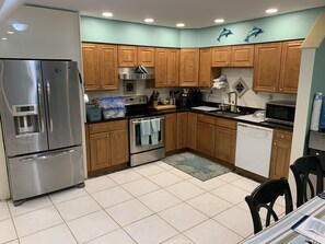 Enjoy cooking in this fully equipped kitchen with a refrigerator, stove, oven, microwave, and dishwasher.
