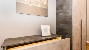 A modern bathroom vanity with a large mirror, a framed quote, and a light fixture above. - GuestHost - Very new apartment equipped with large terrace and totally renovated, able to comfortably accommodate up to 3 people. The flat is located in the quiet Parella district, a very green and well served area: the MM Pozzo Strada stop is only 400m  (Torino)