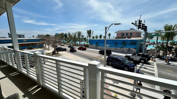 Enjoy the vibrant street scene from your balcony, overlooking a pedestrian crossing and a colorful mural.