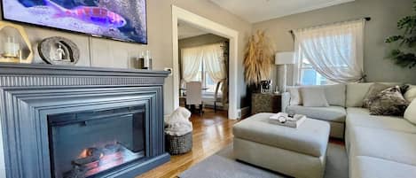 Smart TV, fireplace, books, printers