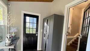 A modern kitchen with a wooden ceiling, a built-in refrigerator, and a view to the outside through a window. - Cozy Home with LOTS of space- Less than 1 mile to ISU & IWU, 5 miles to airport (Normal)