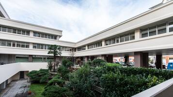 Stunning courtyard with lush greenery and large windows.